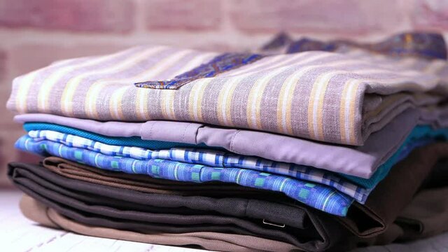 close up of stack of clothes on table .