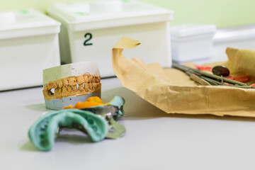 Plaster model of teeth, instrument for dental impression. Next to a set for examination of teeth