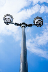 Vintage street lamp in the streets of Beaulieu-sur-Mer, France. A double lamp against the blue sky