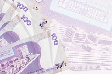 100 Philippine piso bills lies in stack on background of big semi-transparent banknote. Abstract...