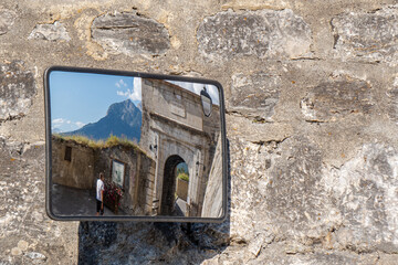 A view of a city gate in a traffic mirror