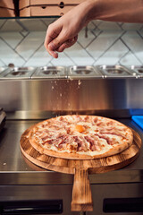 Man adding ingredients on dough
