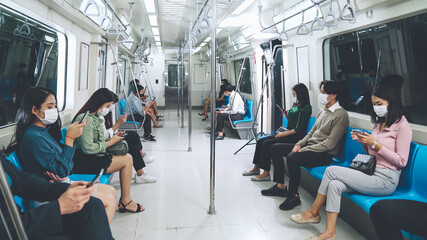 Crowd of people wearing face mask on a crowded public subway train travel . Coronavirus disease or...