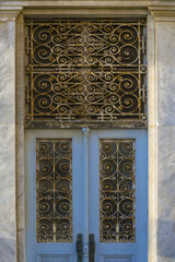 old door with peeling paint in Ermoupoli, Syros island Greece