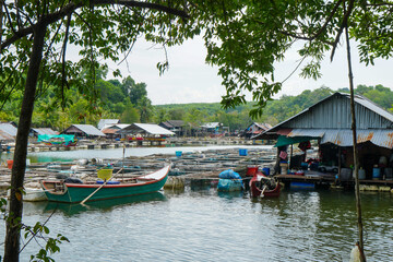 Fishing village in Thailand with boats and metal roofs.
