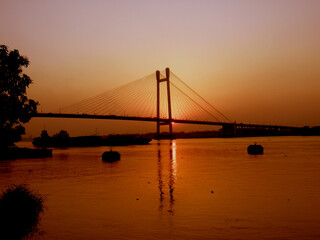 Naklejka na ściany i meble Kolkata Riverfront on the banks of Ganga or Hooghly River, photo taken around sunset time.