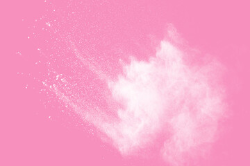 Fototapeta premium Abstract white powder explosion. Closeup of white dust particle splash isolated on pink background.