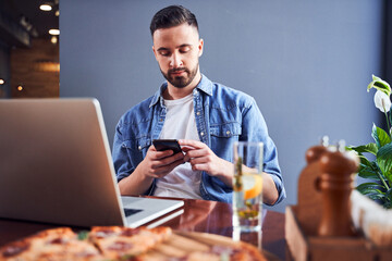 Programmer eating pizza at workplace