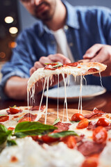 Close up man with beard eating tasty pizza
