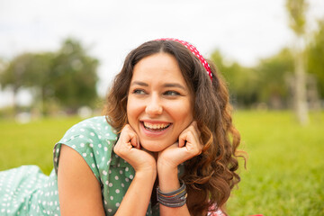 Portrait of young brunette woman having fun in the park