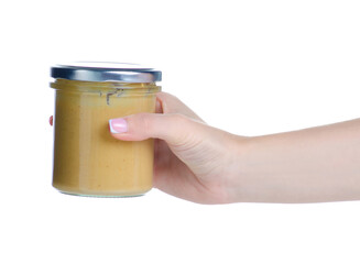 Jar with peanut paste in hand on white background isolation