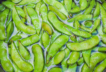 Japanese edamame in water, it is cooked by boiling it in boiling water. Green edamame.