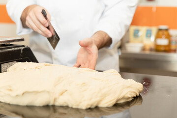 Traditional Italian cuisine: chef prepares pizza dough with water and flour. food photography for menus and websites