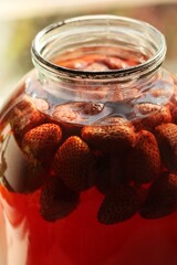 Delicious compote with strawberries in a jar