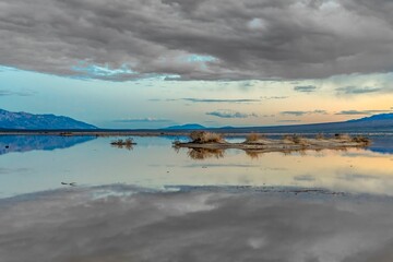 scenic lake near death valley with dark clouds in the national park