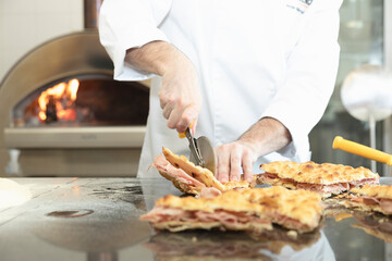 Italian cuisine: preparation of the white, with mozzarella and mortadella. Design serving. professional cook at work, use of hands. food photography for menus and websites
