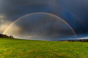 Dopple Rainbow, Thunderstorm is coming with rain, clouds are warm illuminated from the sun,on the horizont blue sky, Kulm, Thuringia, Germany