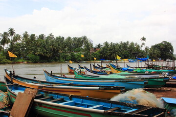 Fototapeta na wymiar Goa, Boats in a river, with blue water and beautiful sky, India