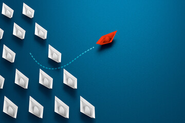 Group of paper boats  and one in different directions - metaphor  individual pointing in the different way. exception Business concept new idea creativity and different innovative solution
