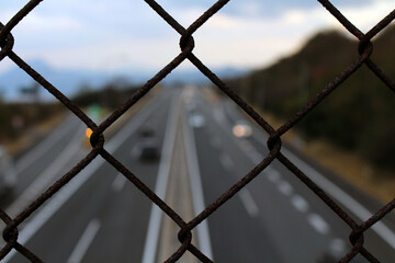 Fence overlooking Japanese highway, taken in Beppu