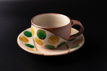 Brown ceramic coffee mugs on black background