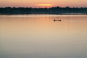 Muong Khong Laos 1/12/2012 Mekong river at dawn with golden sun and fishing boat