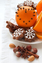 Christmas spices and cookies, orange,  anise and cinnamon sticks on white background. Decoration for Christmas