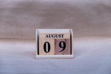 August 9th. Image of August 9 wooden color calendar on white canvas background. empty space for text