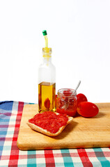 Preparing a toast of good bread, olive oil and tasty tomato juice on a white background.