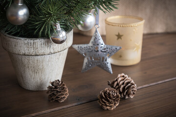 Fototapeta na wymiar Christmas and a New Year background with a Christmas tree, candle and fir cones 