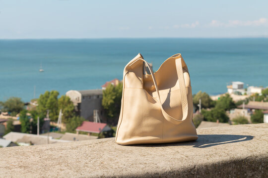 Beige fashion female leather bag outdoors
