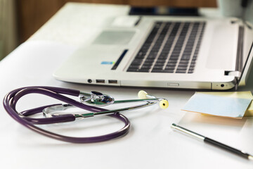 Stethoscope on the table next to laptop