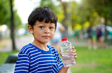 Kid thirsty water and hold transparent plastic water bottle water