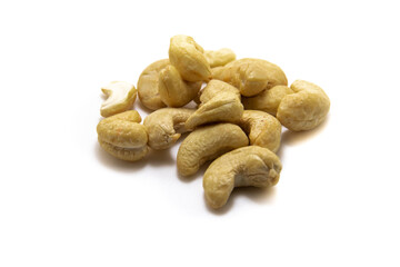 Large pile of cashew nuts on white isolated background macro photo