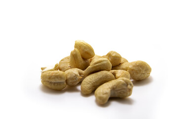 Lot of cashew nuts on white isolated background macro photo