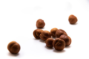 Lots of hazelnuts scattered on white isolated background macro photo