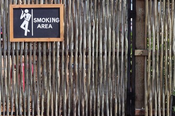 Smoking zone with pole fence backdrop