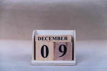 December 9th. Image of December 9 wooden color calendar on white canvas background. empty space for...