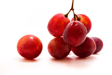 One and bunch of red grapes on white isolated background