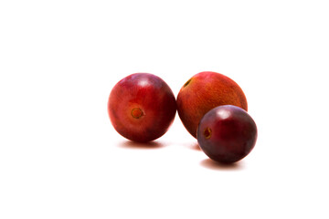 Red grapes of different sizes on white isolated background