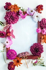 flower arrangement and wooden blank photo frames