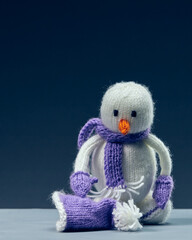 Christmas snowman made of wool. Blue background.
