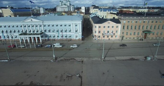 Flying near Kruunuhaka, Helsinki, Finland, browsing significant buildings such as the embassy of Sweden, Helsinki city hall, supreme administrative court of Finland, and the presidential palace.