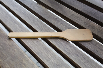 Wooden spoon on a table with several boards.