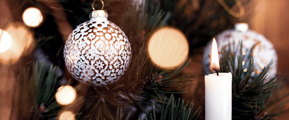 Christmas tree decoration
Christmas tree decoration with balls and candlelight. Horizontal close-up...