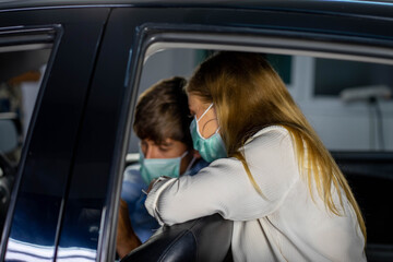 caucasian male driver in public trasportation taxi wearing face protection mask to prevent disease pandemic