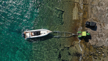 Aerial top view photo of inflatable speed boat on trailer being towed by truck from emerald exotic...