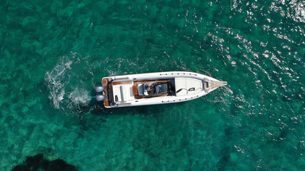 Aerial drone photo of luxury inflatable speed boat cruising in deep blue Aegean sea, Mykonos island, Cyclades, Greece