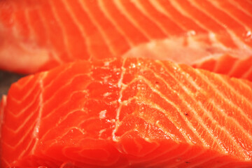 Fresh red salmon fillets and fatty strands inserted between the meat. Slides are beautifully sized pieces that are appetizing.