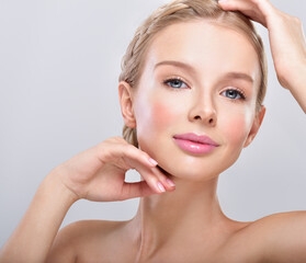 Beautiful face of young adult woman with clean fresh skin.